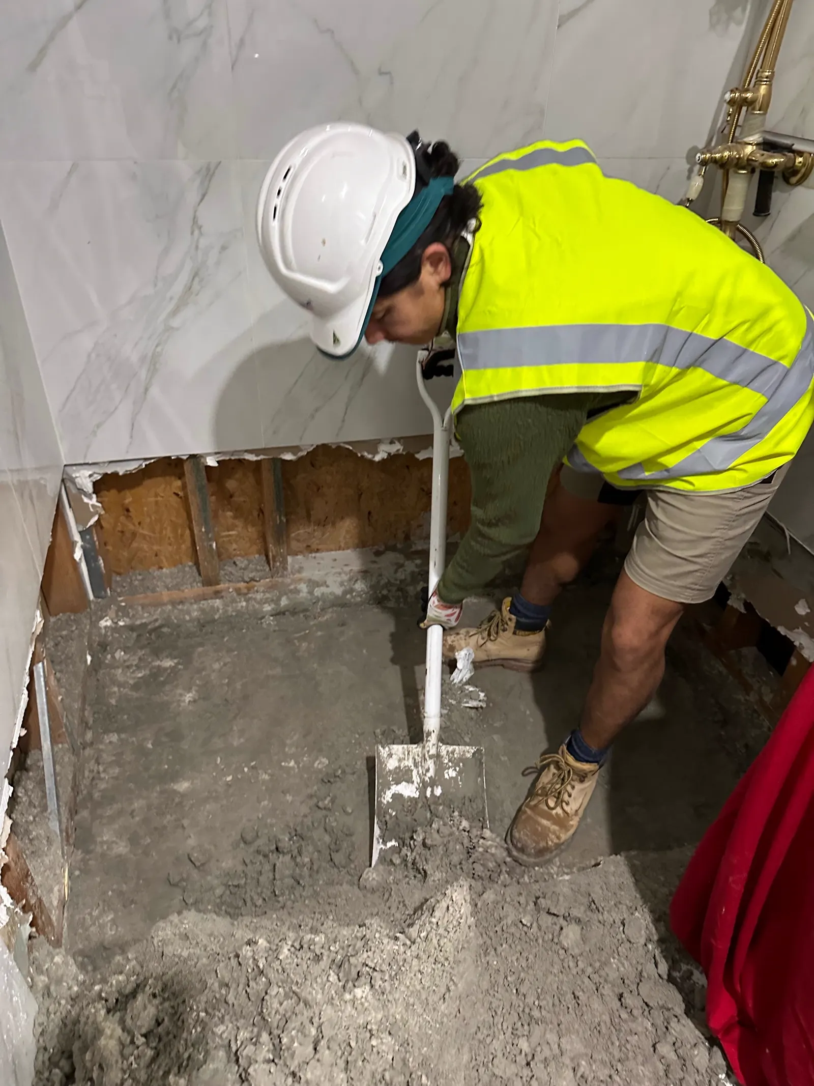 Tiles and substrate removed back to a sound base during a shower repair