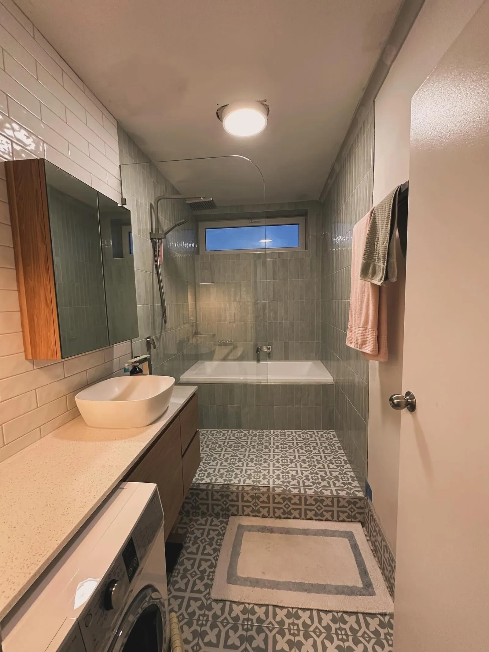 Finished bathroom with tiled floor and fully tiled walls