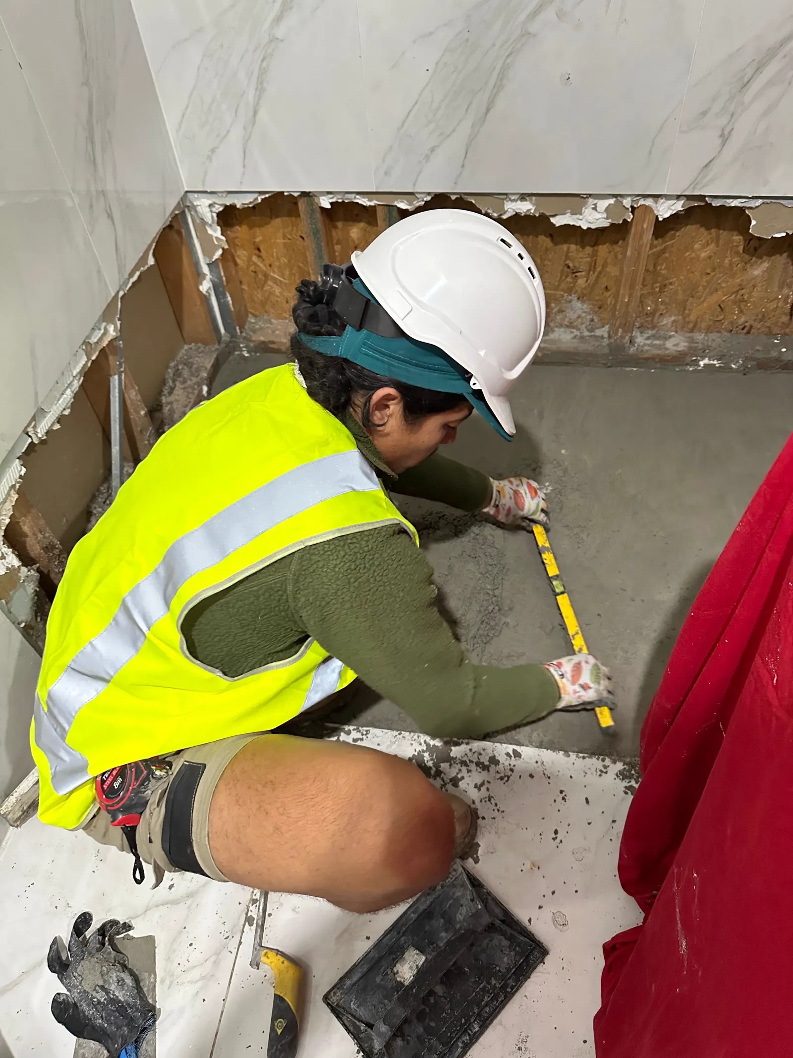Measuring and preparing a bathroom floor for screeding and falls before waterproofing