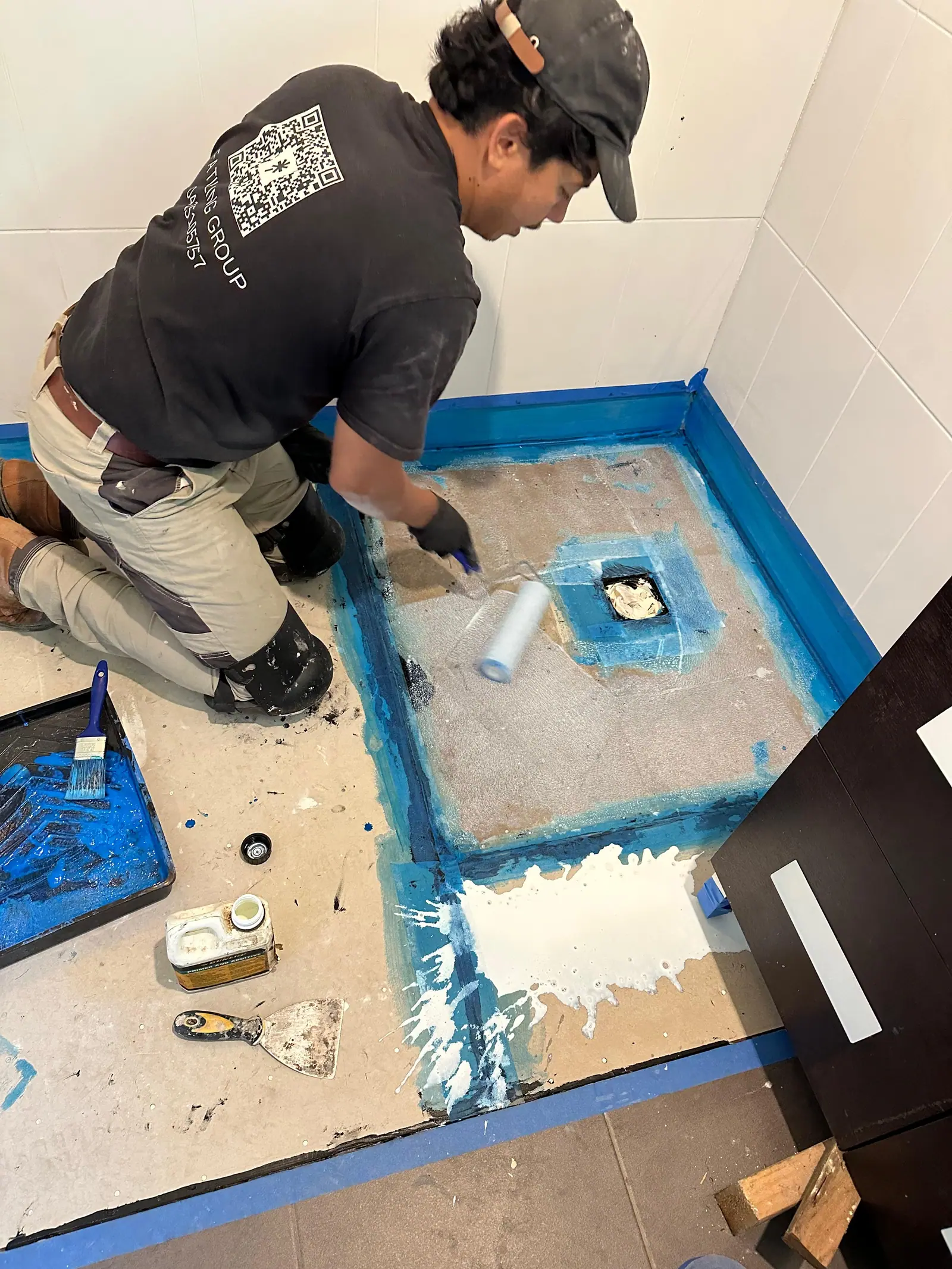 Waterproofing membrane applied across the shower base and wall junctions