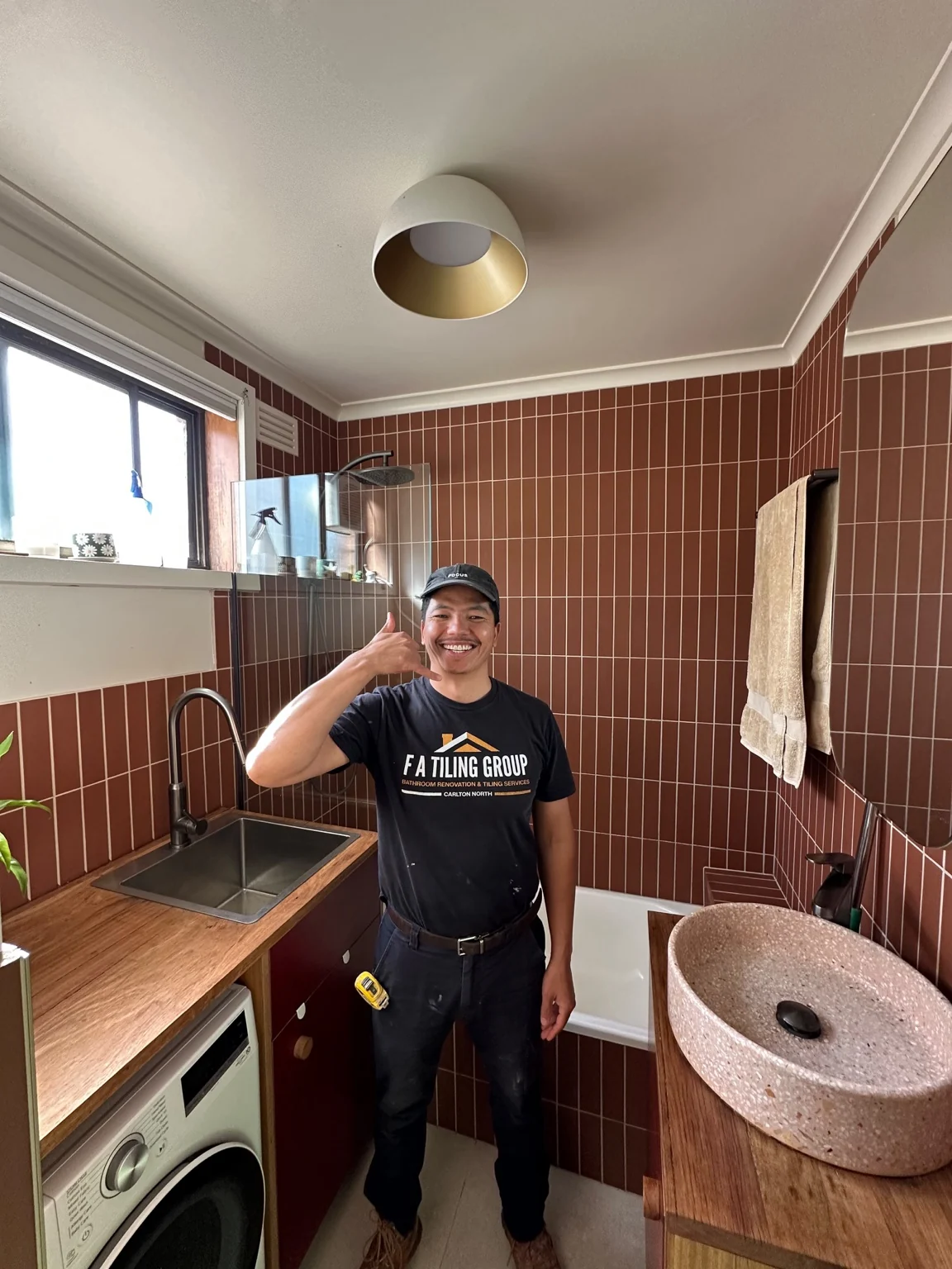 Farid from FA Tiling Group in the finished terracotta tiled bathroom